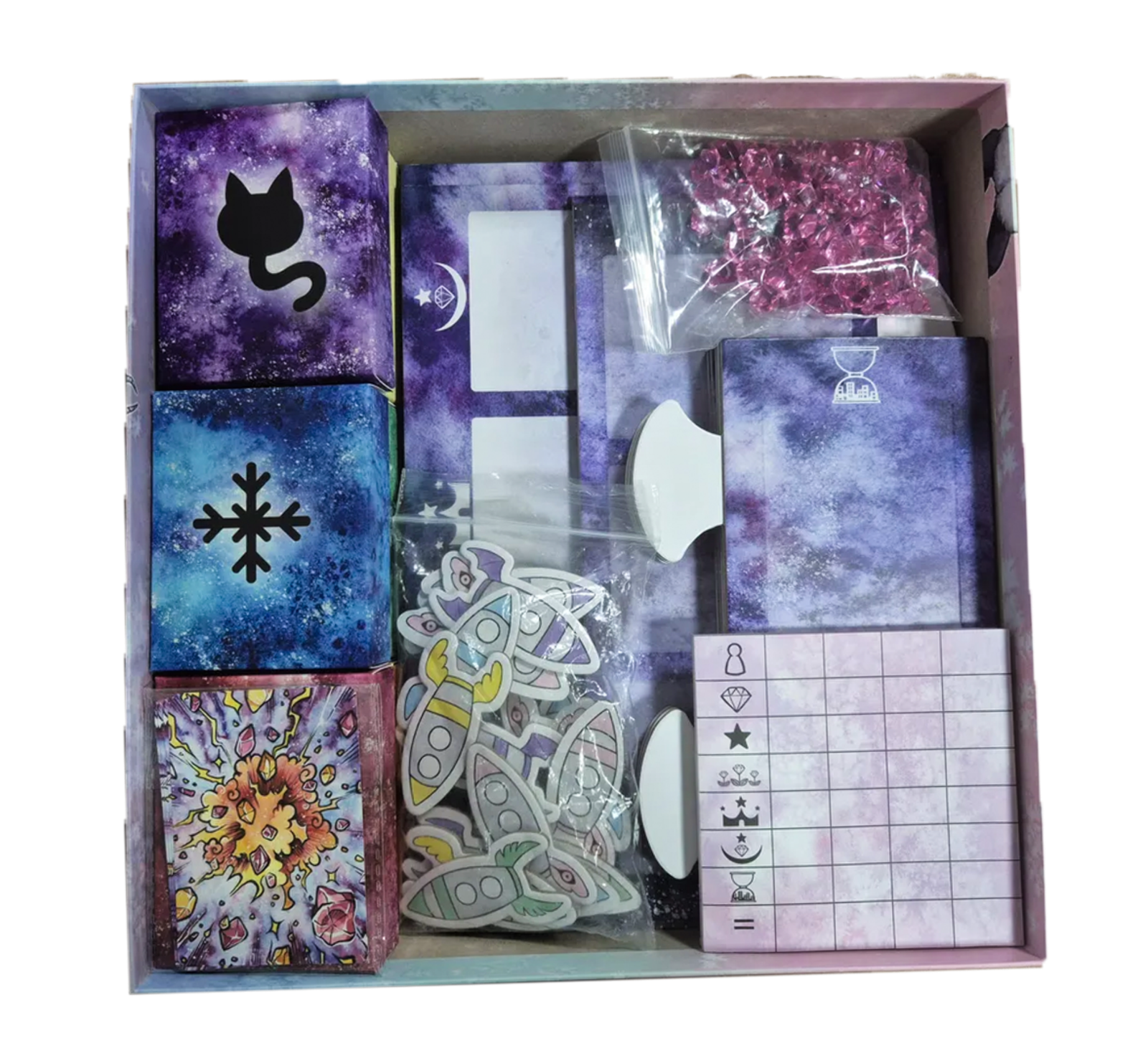 Inside the PuffiNova box showing cards, tokens, and components